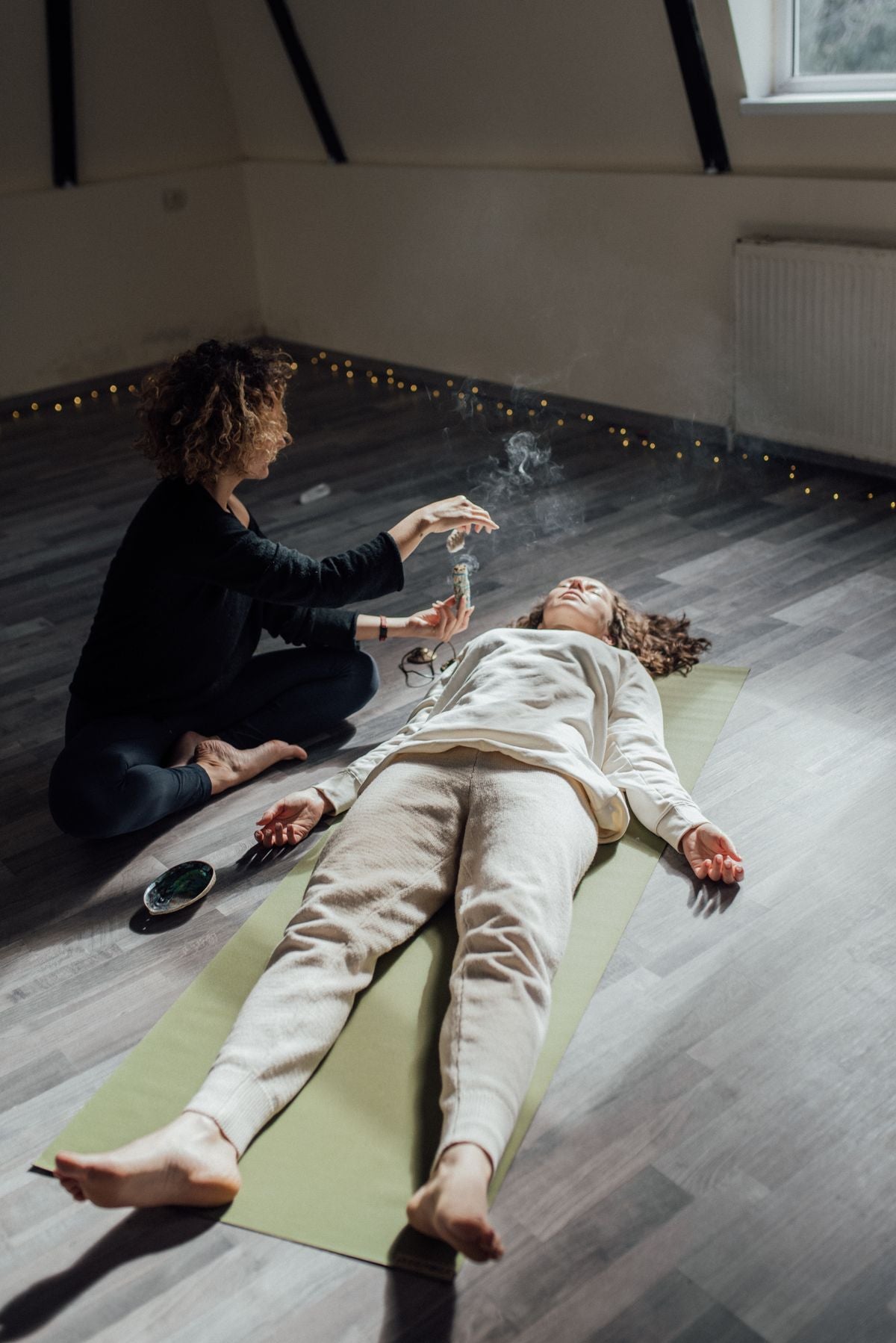 Woman relaxing as incense smoke fills the room
