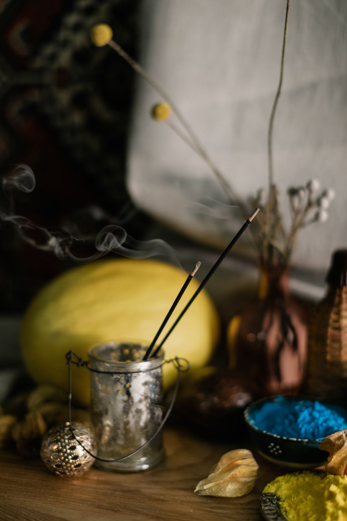 Incense sticks burning in a glass holder on a table